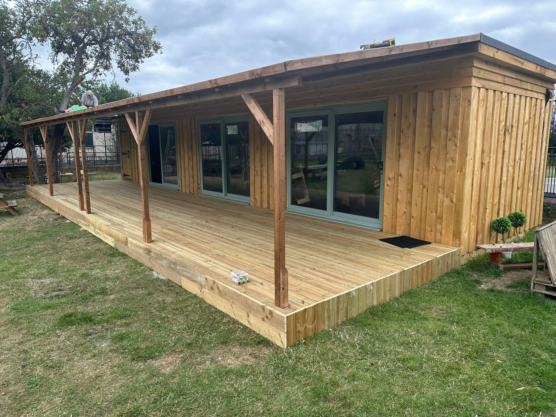 Large timber-clad garden room with deck terrace in Nottinghamshire